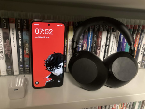 A Fairphone 6, a charger and a set of Sony headphones.