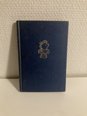 A copy of Winnie Ille Pu. A blue book with a gold colour embossing of a Roman style bust of Winnie-The-Pooh.